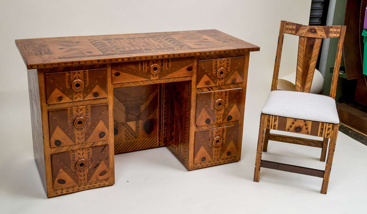 American Folk Art marquetry furniture (California), suite of five pieces. Desk, side chair, lounge chair, ottoman, and coffee table. All pieces constructed of multiple, intricate, thick laminates forming striking symmetrical pattern of dazzling
